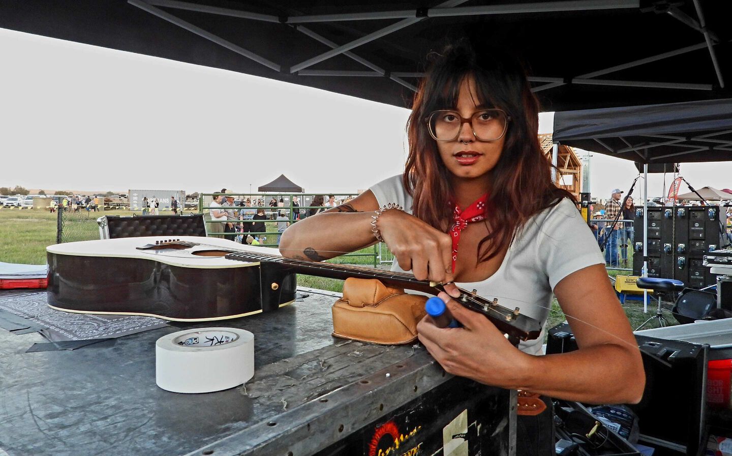 Photo of Peyton Cole stringing up a Martin Guitar